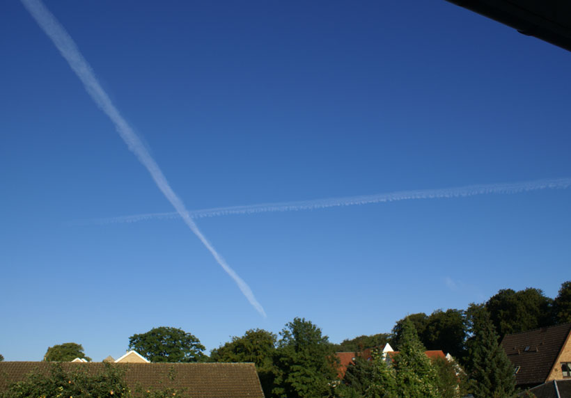 Aircraft condensation trails at different altitudes