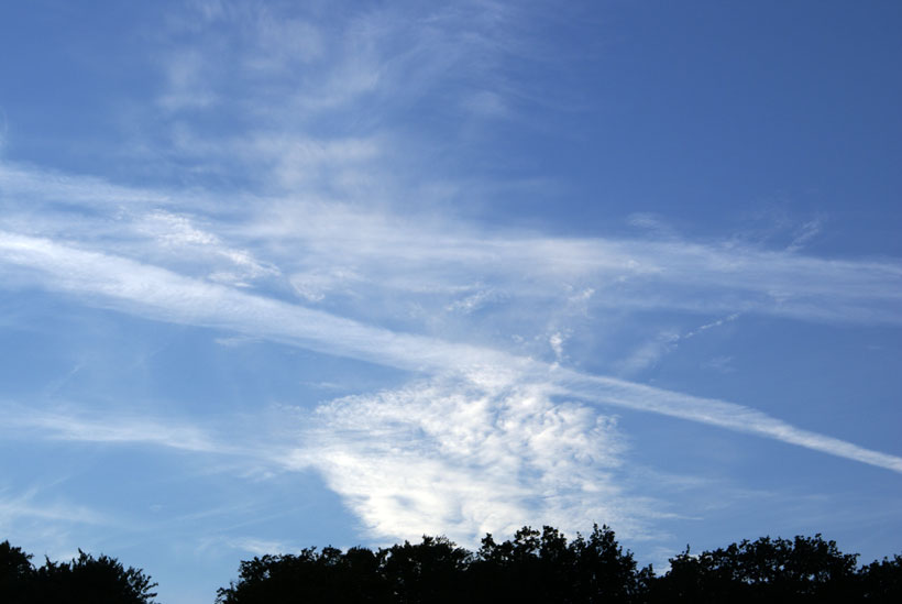 Amazing Cirrocumulus cloud structure below aircraft contrails